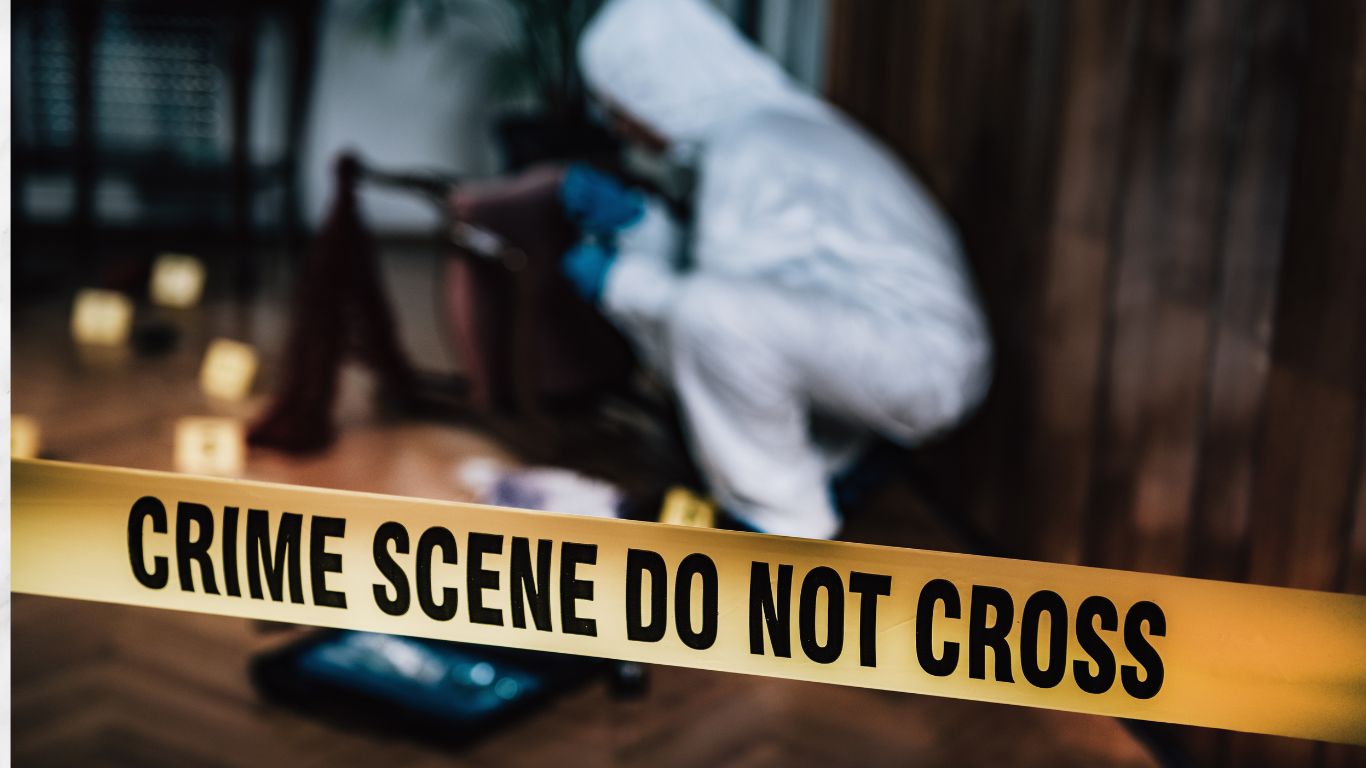 Crime scene cleanup expert in protective gear behind caution tape, restoring safety after an incident.